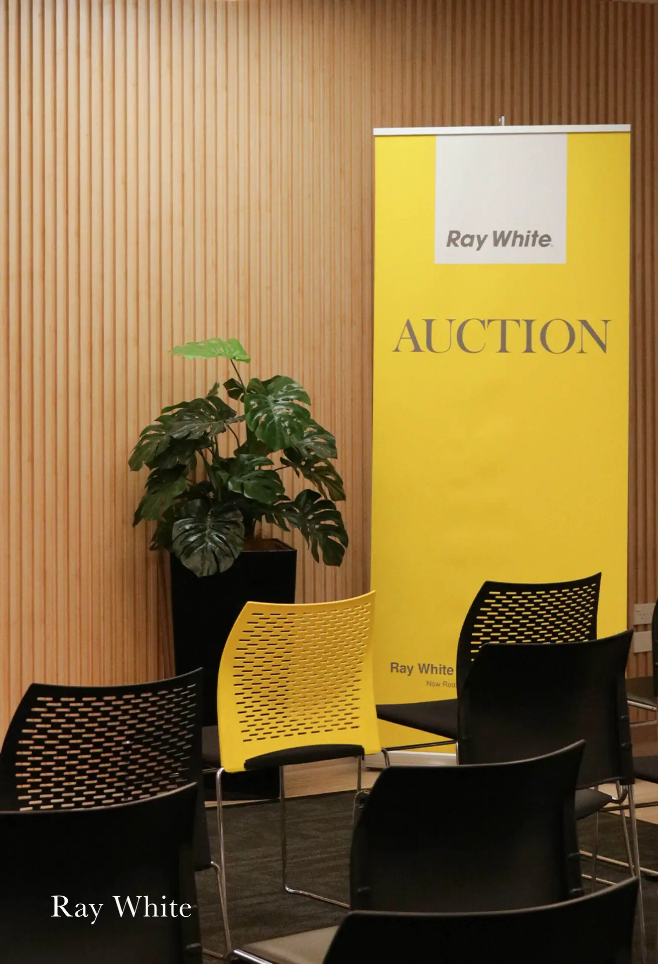 Ray White office with branded signage and clean layout