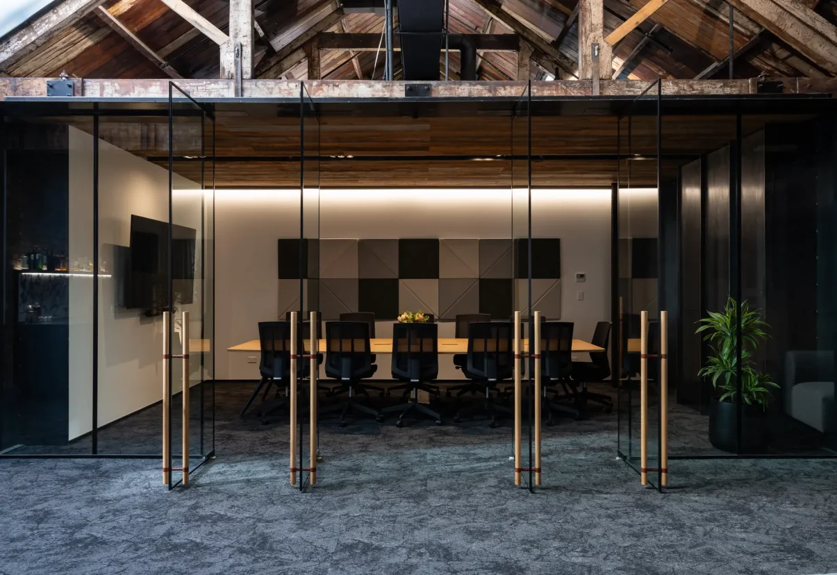 Boardroom space with high-back chairs, plants, and casual seating