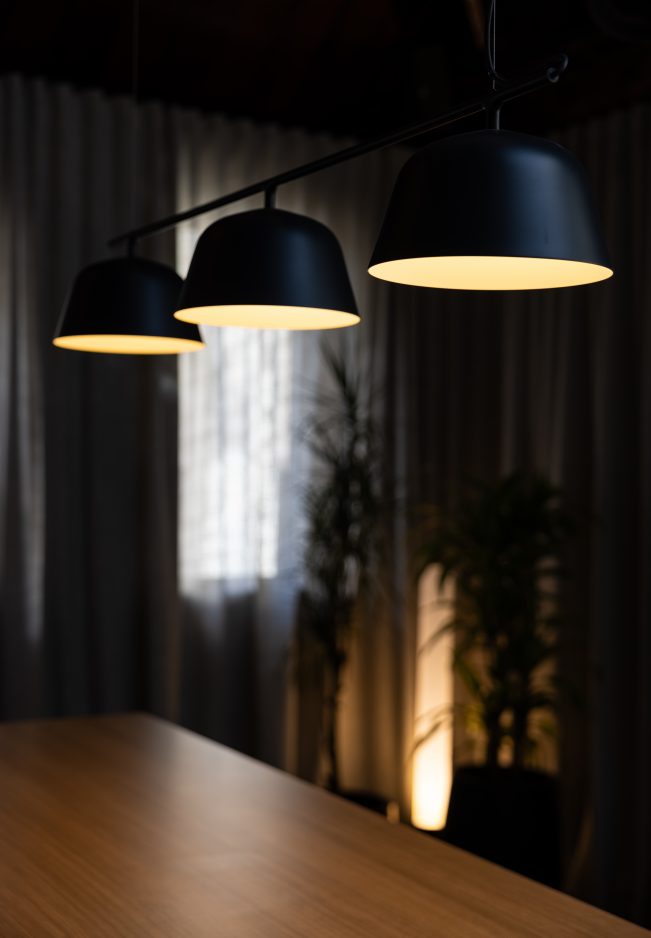 Open-plan workspace with desks, partition screens, and natural lighting