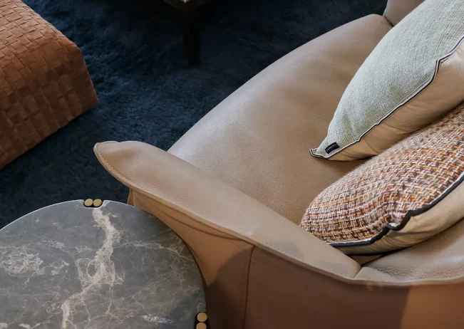 Leather armchair with timber side table in Parnell Residence