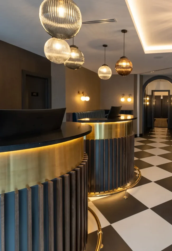 Check-in area with black and white tiled floor and front desks at TRYP Wellington