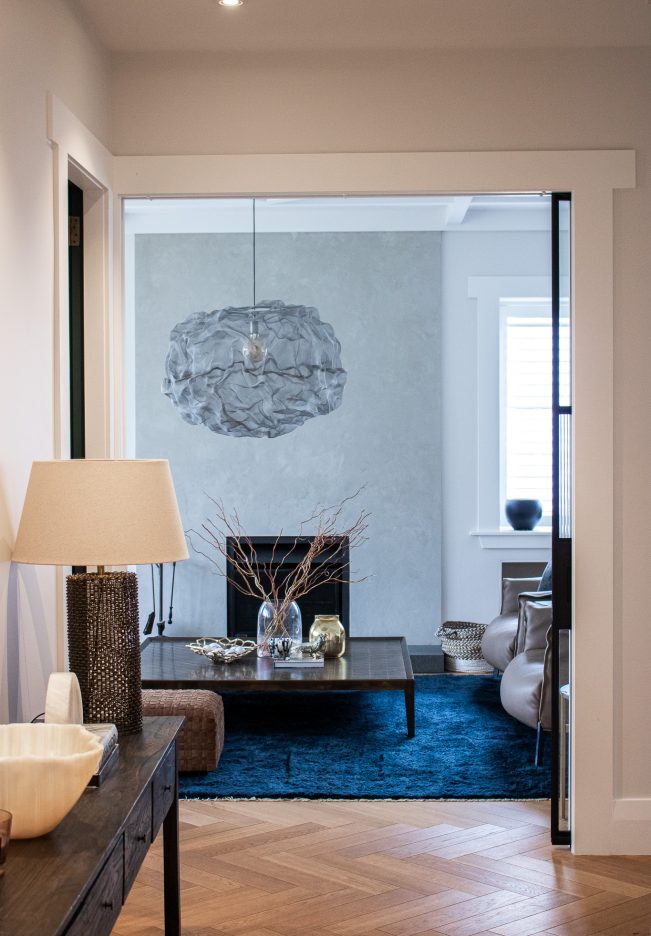 Hallway leading to lounge with pendant light and timber flooring