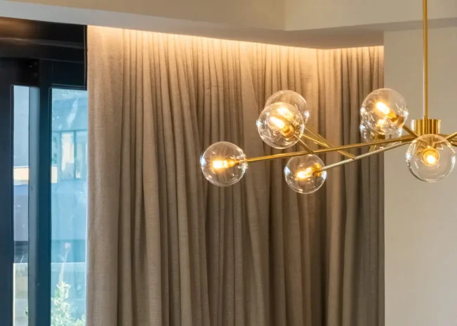 Gold-toned pendant lighting in TRYP Penthouse interior