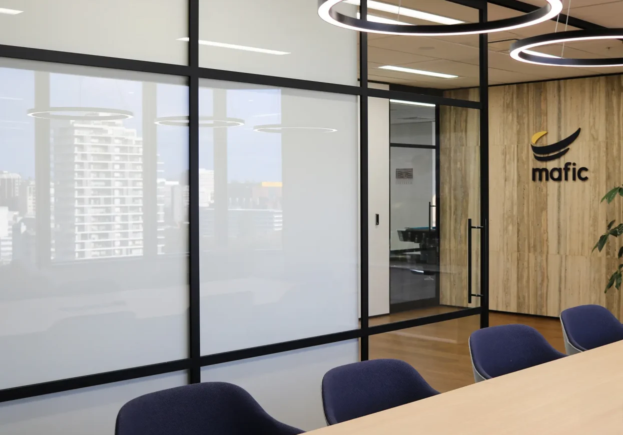 Mafic Partners boardroom with logo signage on timber wall