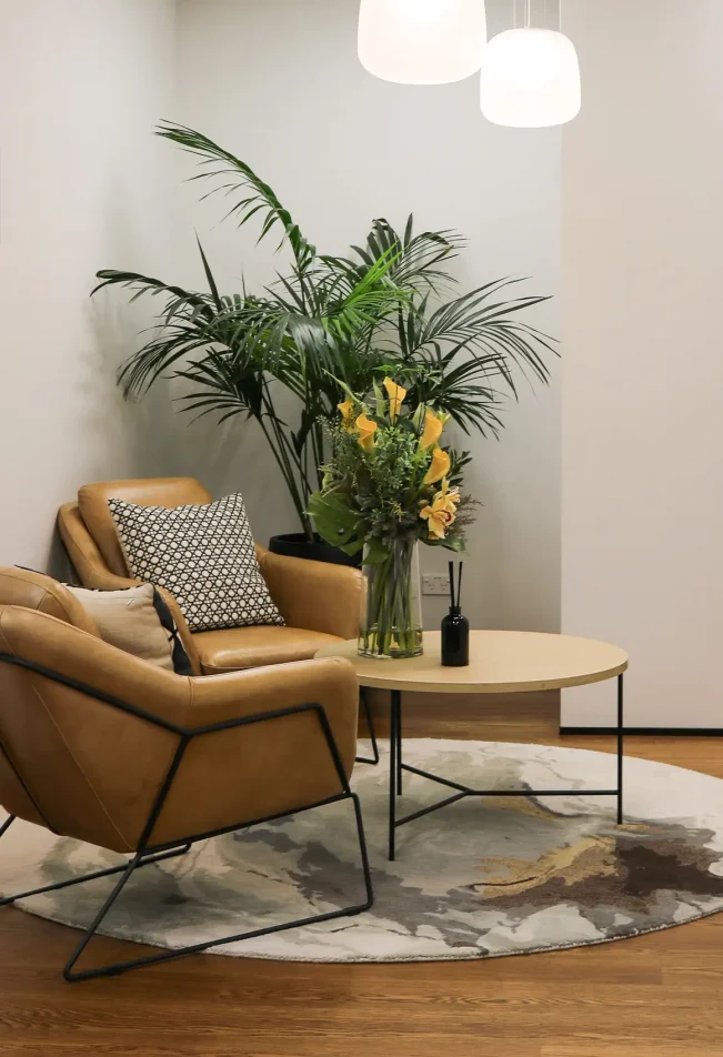 Waiting area with upholstered chairs and soft lighting