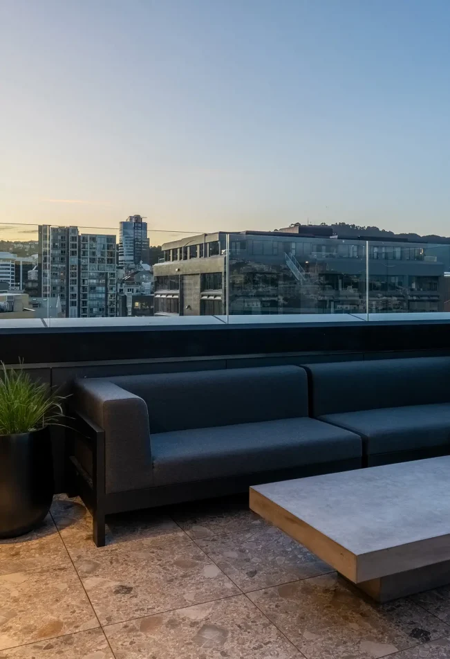 TRYP Penthouse balcony with outdoor seating and city backdrop