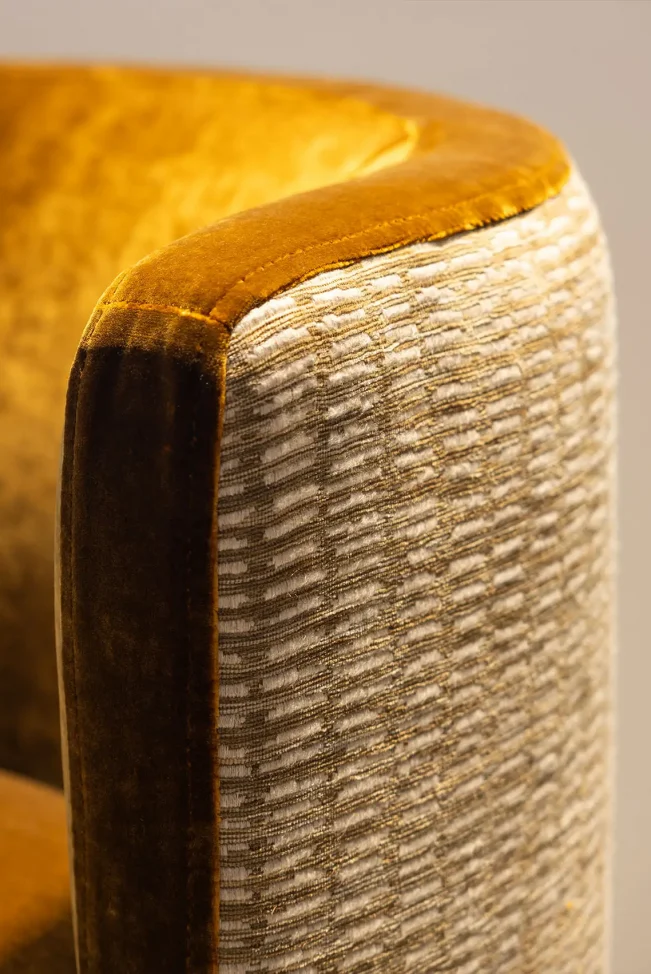 Yellow cushioned chair in Cambridge Suite referencing Cambridge Stud brand colours