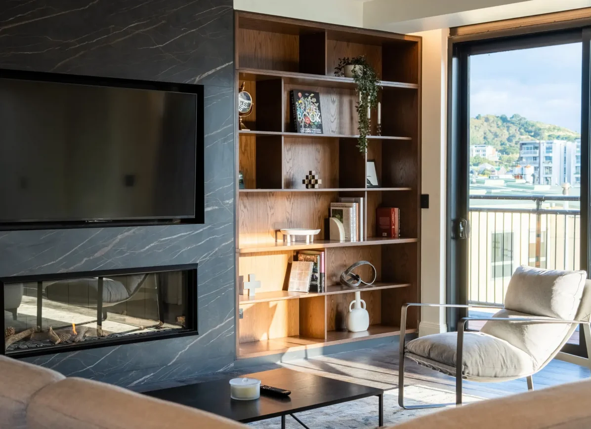 TRYP Penthouse lounge with fireplace, TV, and curved seating