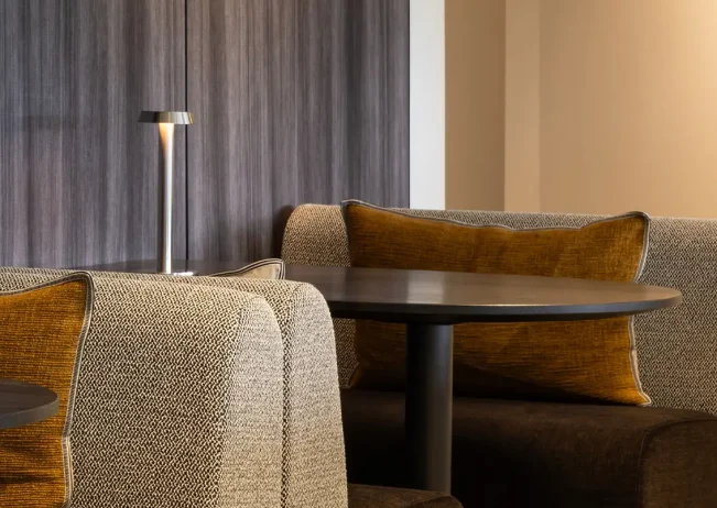 Dining tables with timber chairs in Cambridge Suite interior